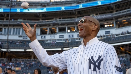 Rutgers President-Designate William F. Tate IV throws out the first pitch at Yankee Stadium in Bronx, N.Y.